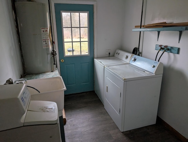 laundry area featuring laundry area, water heater, dark wood-style floors, and washer and clothes dryer