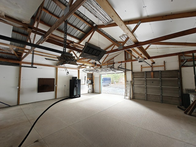 garage featuring metal wall and a garage door opener