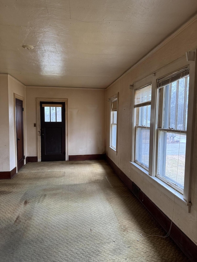 entrance foyer with carpet floors and baseboards