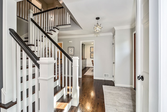 entrance foyer featuring visible vents, crown molding, baseboards, stairs, and dark wood-style flooring