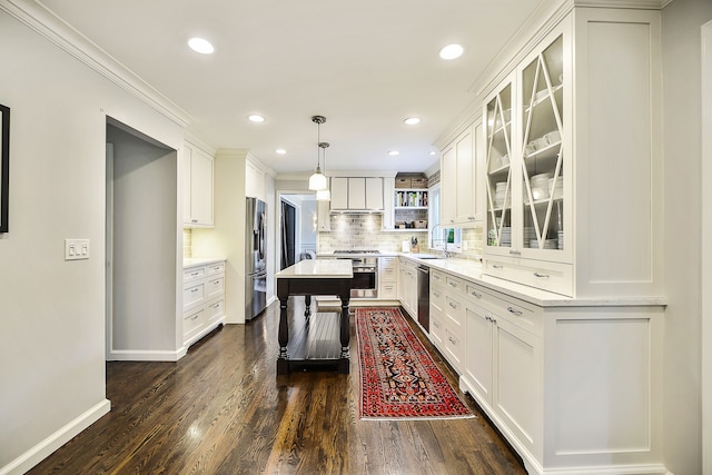 kitchen with a sink, backsplash, white cabinetry, stainless steel appliances, and dark wood-style flooring