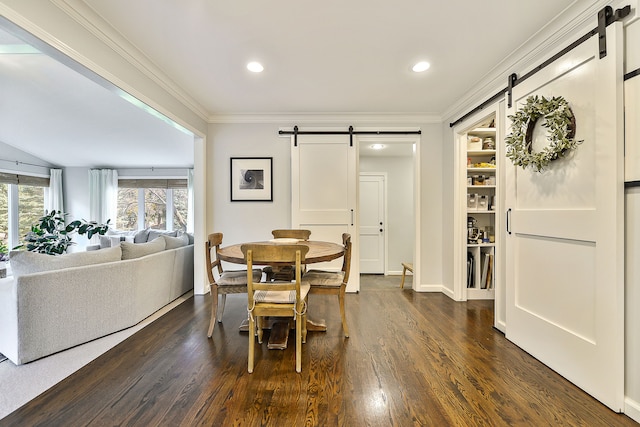 dining room with a barn door, recessed lighting, dark wood-style floors, and ornamental molding