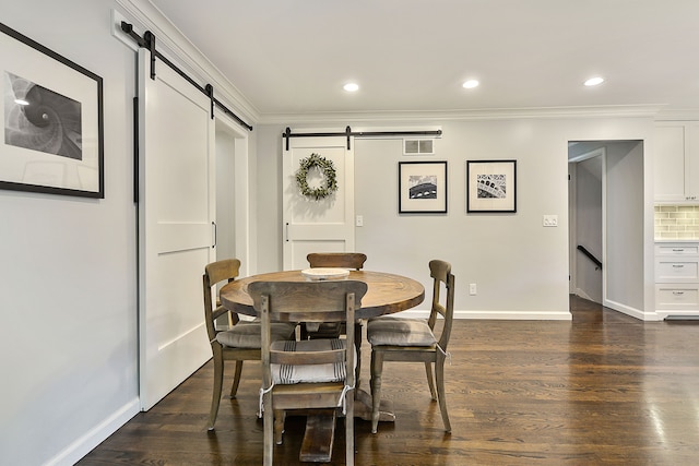 dining area with a barn door, baseboards, dark wood-style floors, and crown molding