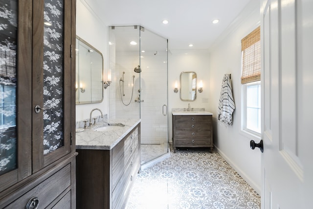 full bath featuring baseboards, two vanities, recessed lighting, a stall shower, and a sink