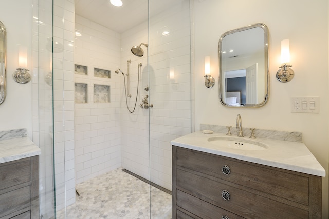 full bath featuring vanity and a tile shower