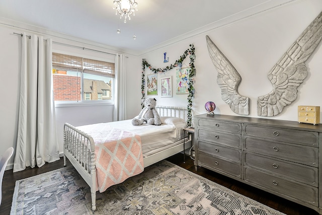 bedroom with crown molding and dark wood-style floors