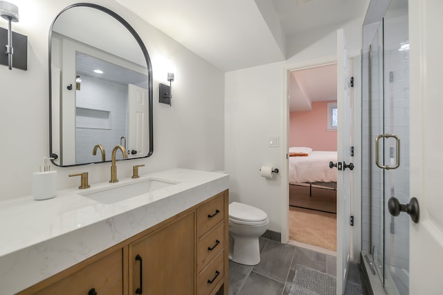 bathroom featuring ensuite bathroom, a stall shower, toilet, and vanity