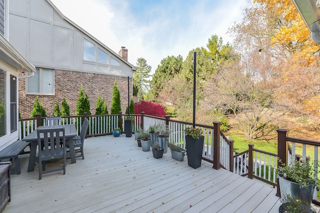 wooden terrace featuring outdoor dining area