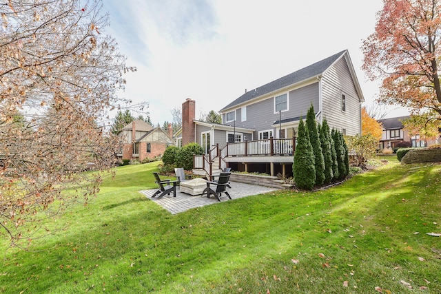 back of house featuring a patio area, a lawn, and a deck