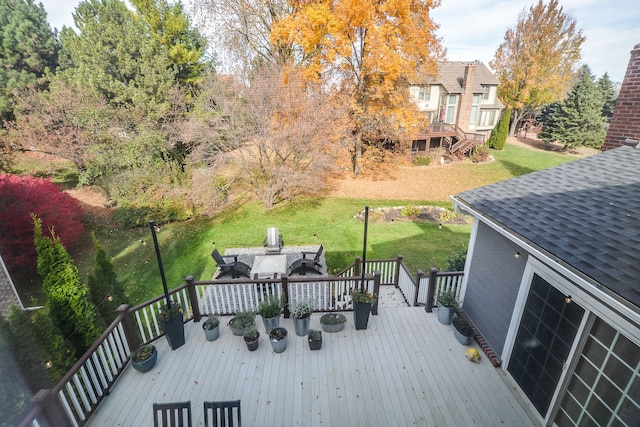 deck with a lawn and outdoor dining space