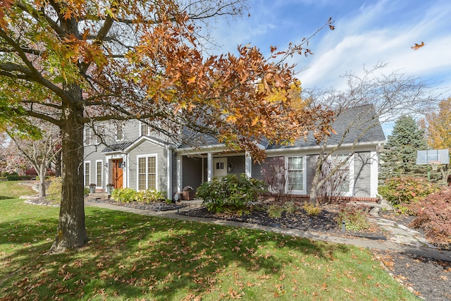 view of front of house with brick siding and a front yard