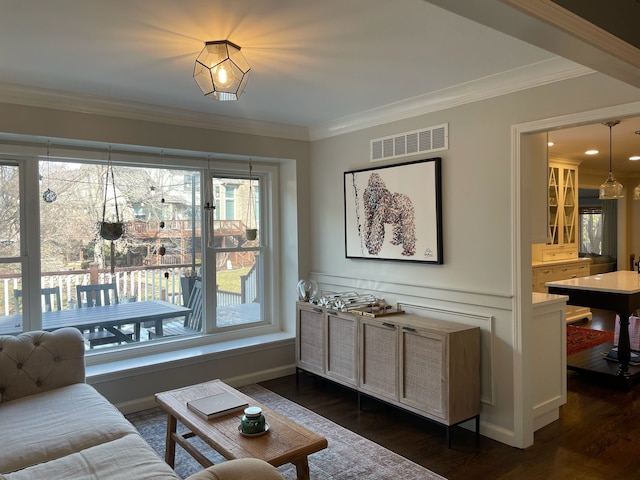 living room featuring visible vents, dark wood-style floors, and crown molding