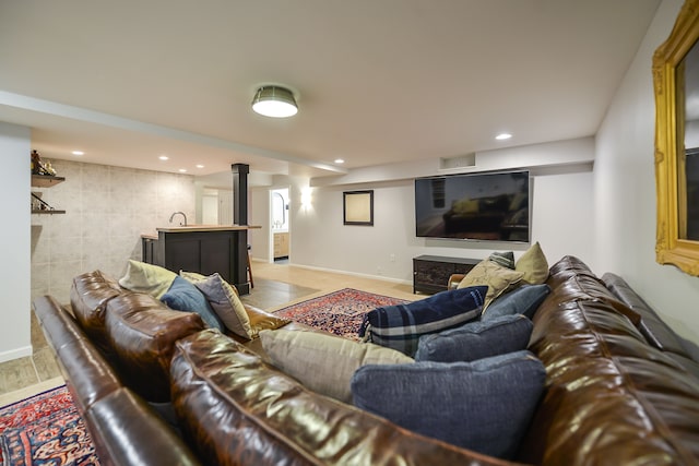 living area with recessed lighting, baseboards, and light wood finished floors