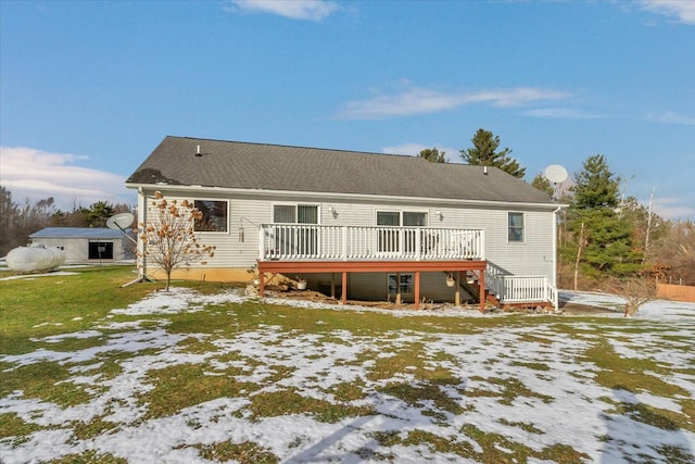 snow covered rear of property with a wooden deck and stairs