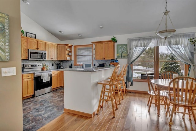 kitchen with decorative backsplash, stainless steel appliances, light wood-style floors, and open shelves