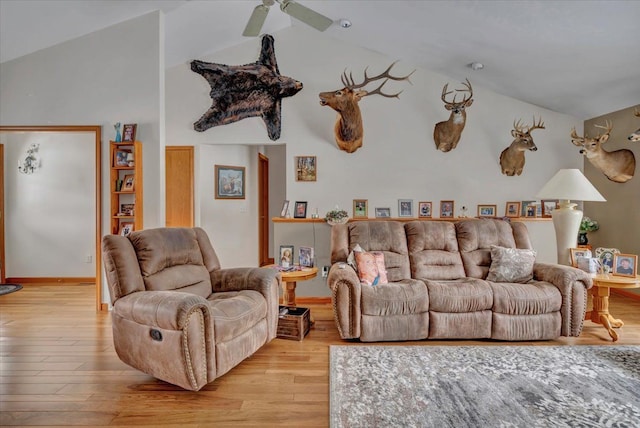 living area featuring a ceiling fan, lofted ceiling, and wood finished floors