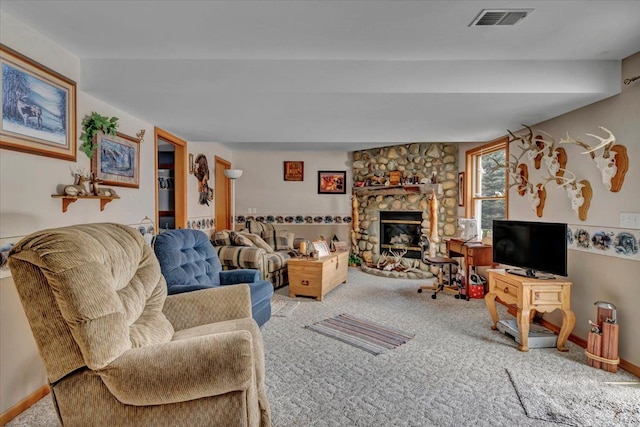 carpeted living room with visible vents, baseboards, and a stone fireplace