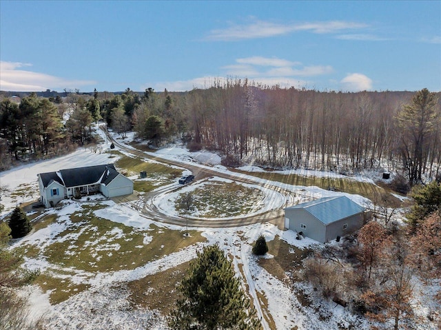 snowy aerial view with a view of trees