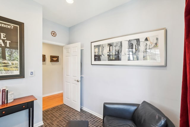 living area featuring baseboards