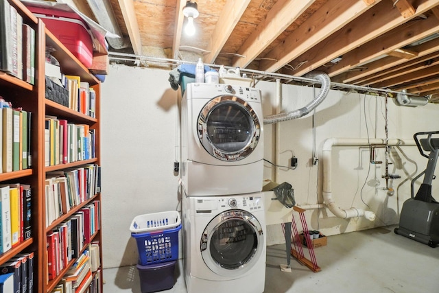 clothes washing area featuring laundry area and stacked washer / drying machine