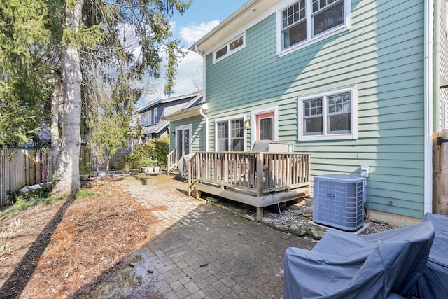 back of property featuring a patio area, fence, a wooden deck, and central air condition unit