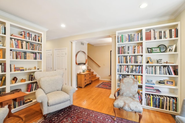 sitting room featuring stairway, recessed lighting, wood finished floors, and crown molding