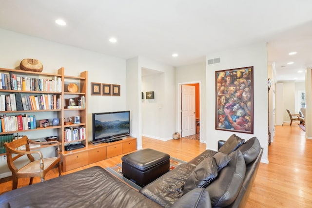 living area with visible vents, wood finished floors, and recessed lighting