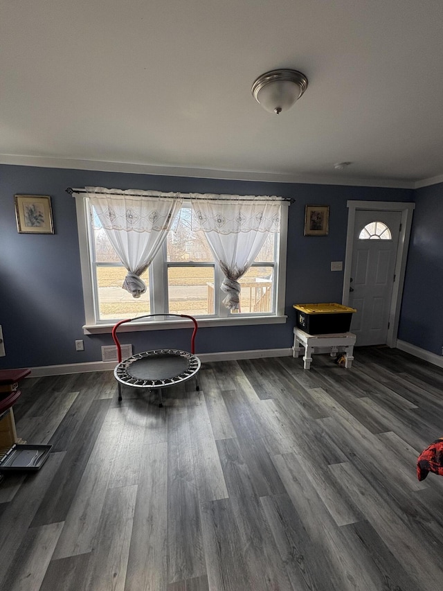 dining area with visible vents, baseboards, dark wood finished floors, and crown molding