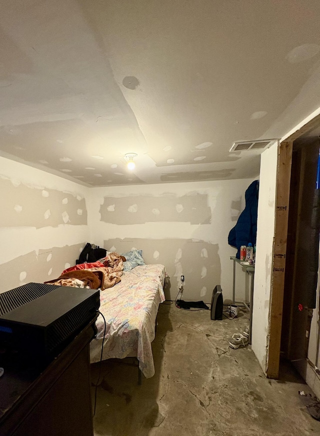 bedroom with concrete floors and visible vents