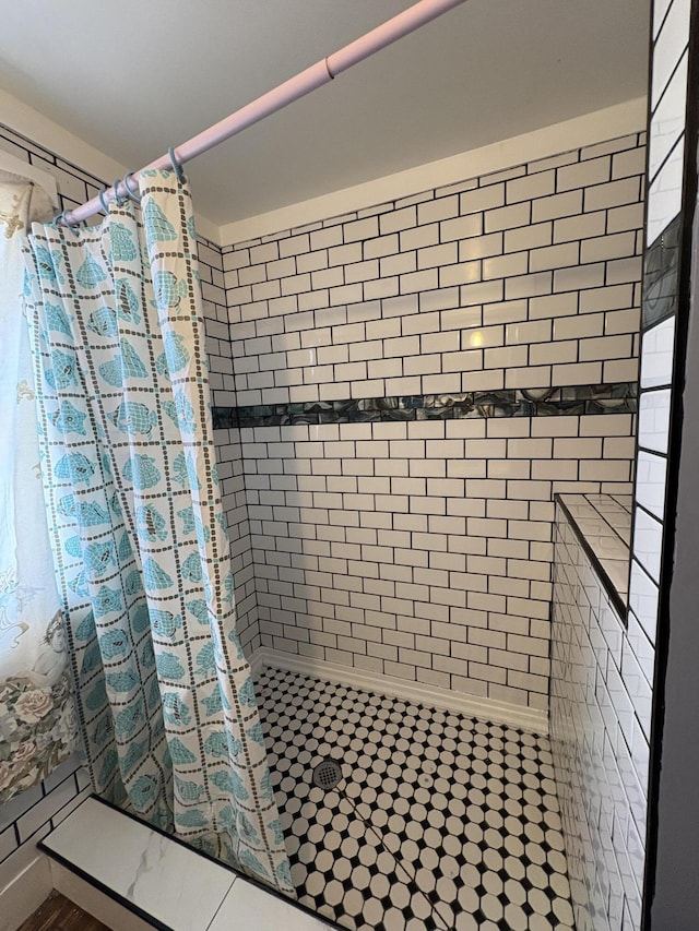 bathroom with a tile shower