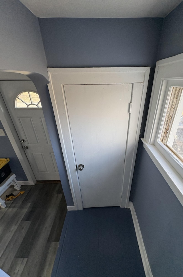 doorway to outside featuring dark wood finished floors and baseboards