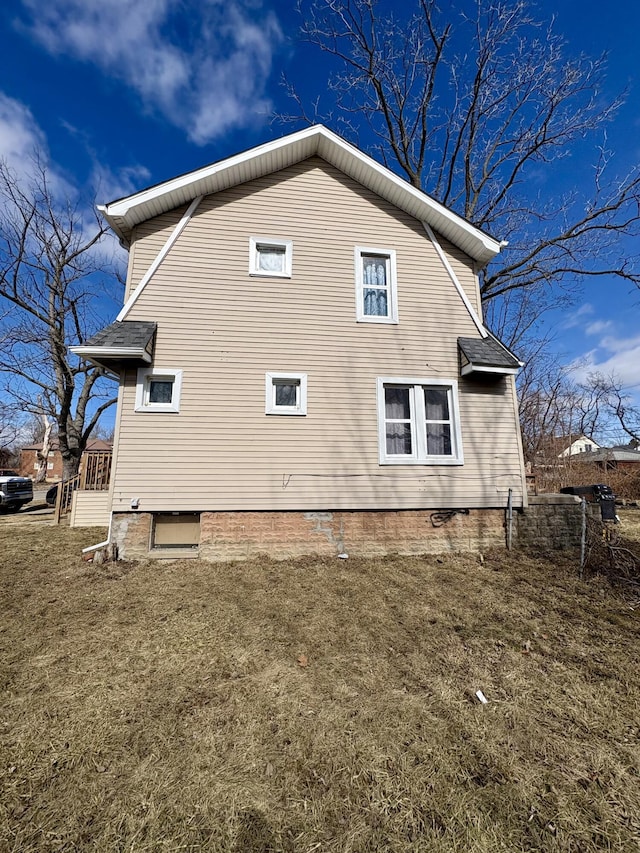 view of home's exterior with a lawn