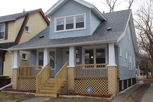 view of front of property with covered porch and a shingled roof