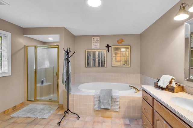 full bath with a garden tub, a shower stall, vanity, baseboards, and tile patterned floors