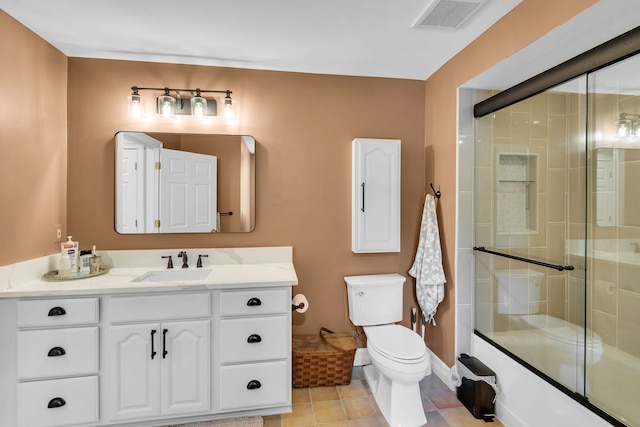 full bath with visible vents, toilet, tile patterned flooring, an enclosed shower, and vanity