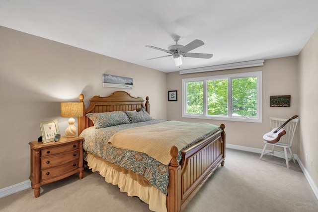 carpeted bedroom with a ceiling fan and baseboards