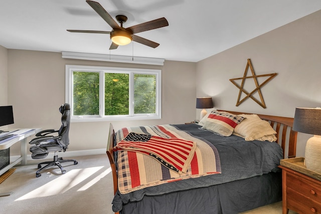 carpeted bedroom with a ceiling fan and baseboards