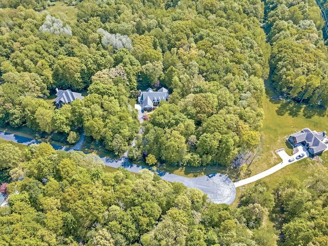 birds eye view of property featuring a view of trees