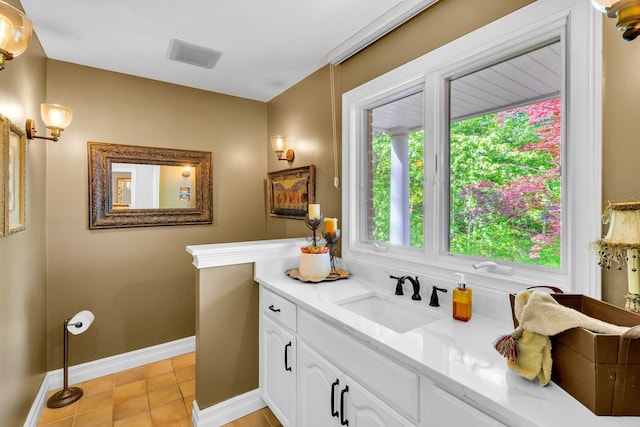 bathroom with tile patterned floors, baseboards, visible vents, and vanity