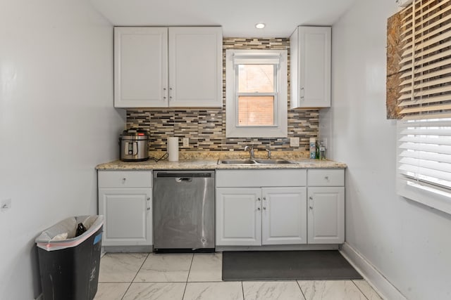 kitchen featuring a sink, white cabinets, marble finish floor, dishwasher, and tasteful backsplash