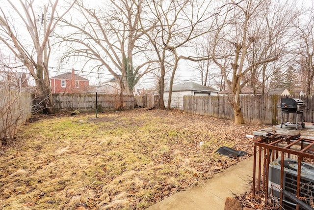 view of yard featuring a fenced backyard and central AC unit