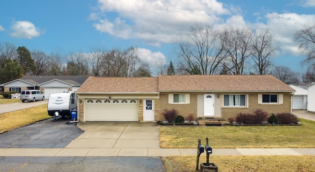 ranch-style home with a front yard, driveway, a shingled roof, a garage, and brick siding