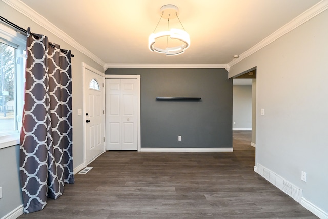 entrance foyer featuring baseboards, wood finished floors, visible vents, and ornamental molding