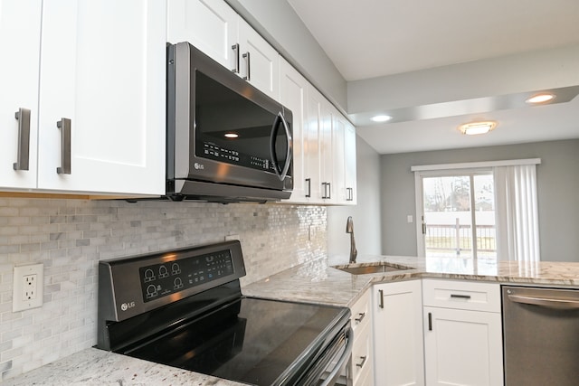 kitchen featuring white cabinets, stainless steel appliances, and a sink