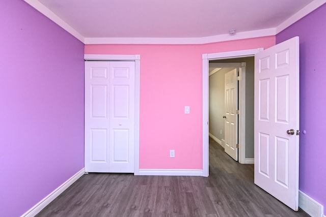 unfurnished bedroom featuring dark wood finished floors, visible vents, and baseboards