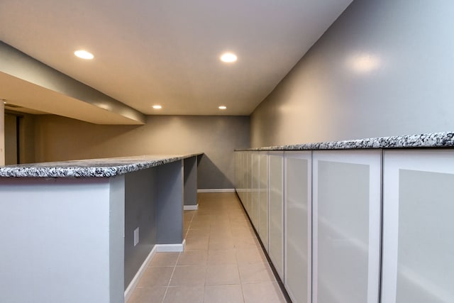 bar featuring recessed lighting, baseboards, and light tile patterned floors