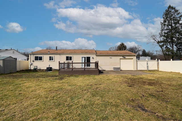 rear view of property featuring an outdoor structure, a storage shed, a fenced backyard, and a gate