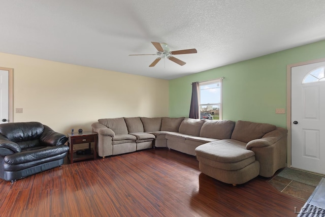 living room with dark wood finished floors and a ceiling fan