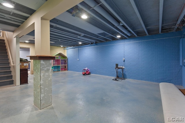 finished below grade area with brick wall and stairs