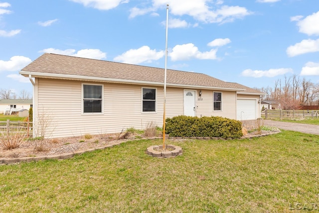 ranch-style home with driveway, a front lawn, and fence